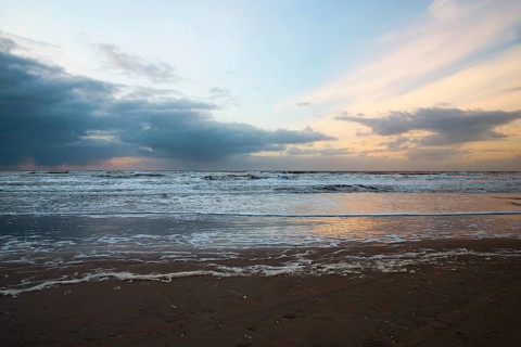 Wadden sea at low tide, North sea beach landscape, coast on Romo island in Denmark at sunset,