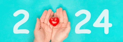New year 2024, calendar date, red heart in the palms of the hands, charity concept, new goals and