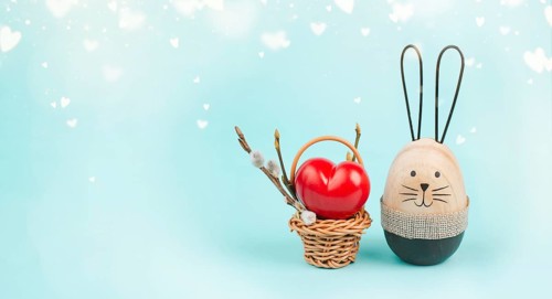 Wicker basket with a big red heart and an easter bunny, rabbit brings gift of love, greeting card