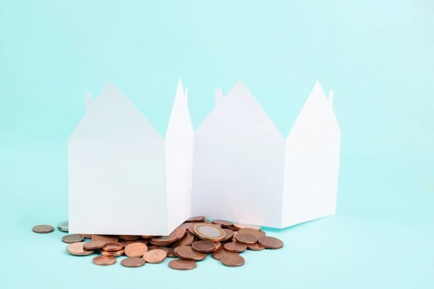 Paper house with Cent coins, planning to buy, build or rent a new home, real estate concept, owning