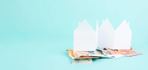 Paper house with Euro banknotes, planning to buy, build or rent a new home, real estate concept,