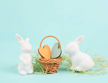 Wicker basket with hearts and an easter bunny, rabbit brings gift of love, greeting card for