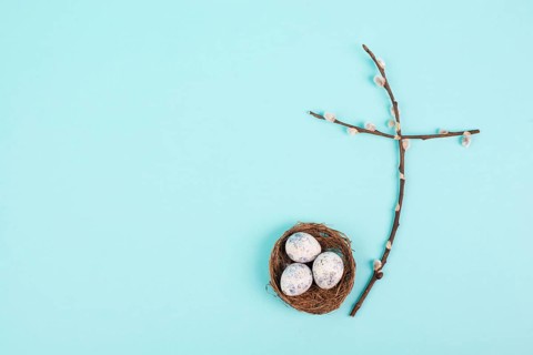 Religious cross made from willow branches, easter nest with eggs, belief, faith and spirituality in