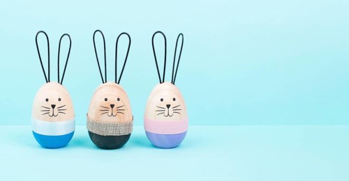 Easter bunny or rabbit group, holiday background and greeting card, painted wooden egg