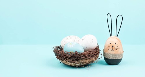 Easter bunny or rabbit group with wicker basket, willow branches, wooden egg, spring holiday