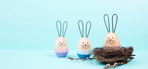 Easter bunny or rabbit group with wicker basket, willow branches, wooden egg, spring holiday