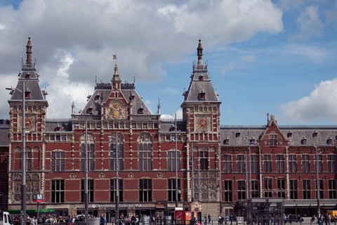 Historic Amsterdam Central Station with towers and colourful bricks, Amsterdam, Netherlands
