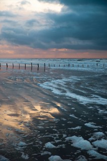 Wadden sea at low tide, North sea beach landscape, coast on Romo island in Denmark at sunset,