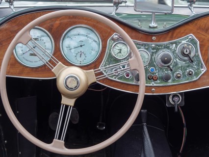 Interior view of a classic car with detailed dashboard and classic steering wheel, winterswijk,