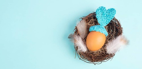 Easter bunny or rabbit in a bird nest, made from an egg and crocheted ears, spring holiday,