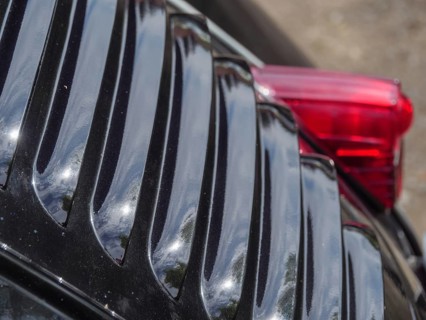 Close-up of a black vintage car, showing air vents and reflective surfaces, winterswijk,