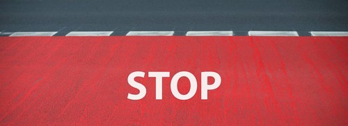 Stop is standing on the road, warning sign, take caution, finish line for a runner on the asphalt,