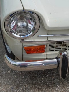 Close-up of a vintage car, showing the front headlight and part of the bumper, winterswijk,