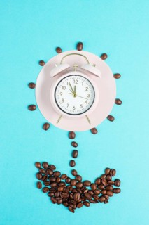 Alarm clock, flower from roasted coffee beans, wake up and have energy from caffeine, time for a