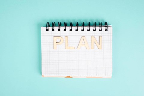 Plan is standing in a notebook, planning new goals, to do list, new year resolutions