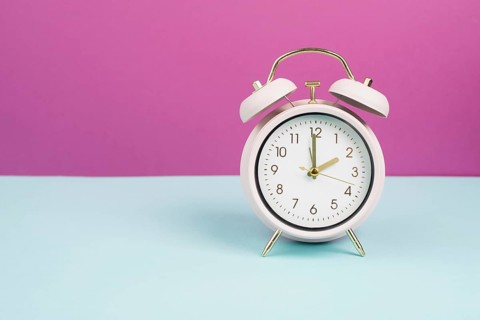 Alarm clock in old retro style, pastel color, time to wake up in the morning