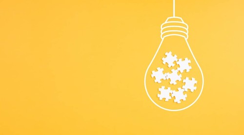 Light bulb with jigsaw or puzzle pieces, brainstorming for ideas, finding solution, solving a