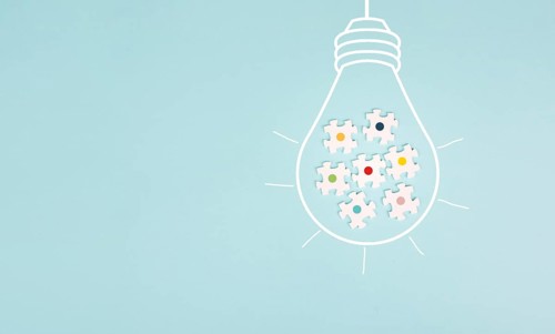 Light bulb with jigsaw or puzzle pieces, brainstorming for ideas, finding solution, solving a
