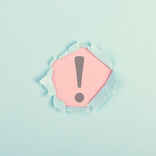 Exclamation mark surrounded by torn paper, alert sign, information and warning concept