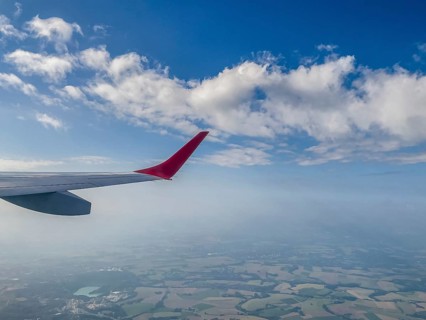 View from aircraft window of upwardly curved extended wing wing tip for better flow behaviour on