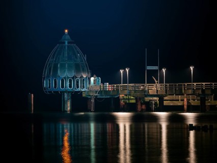 Diving gondola at the illuminated pier in Zingst at night, baltic sea, Mecklenburg-Western