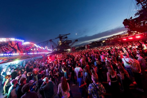Festival visitors celebrate between excavators at the Melt Festival in Ferropolis on 12 July 2024.