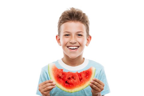 Handsome smiling child boy hand holding red ripe watermelon fruit food slice white isolated