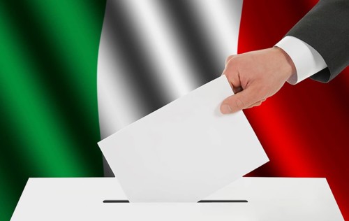 The Italian flag and the hand with the bulletin about the ballot box