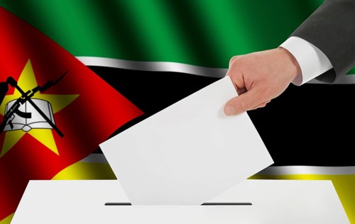 The Mozambique flag and the hand with the bulletin about the ballot box