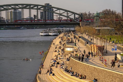 Rhine promenade, Rhine boulevard, on the Deutz bank, people sitting in the spring sun on the Rhine,
