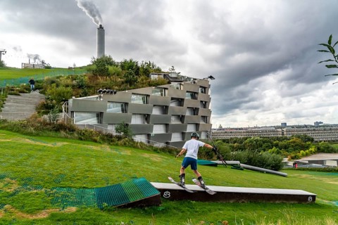 CopenHill, waste incineration plant and artificial ski slope, skiing with a view of the ski lift,