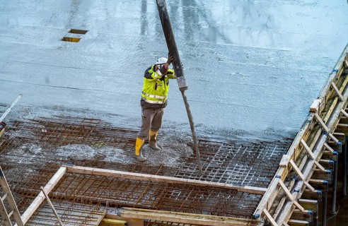 Construction site, concreting, floor, ceiling for a building is concreted, the concrete is pumped
