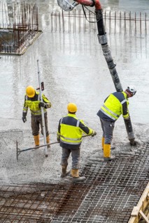 Construction site, concreting, floor, ceiling for a building is concreted, the concrete is pumped