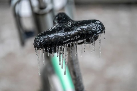 Freezing rain, icy saddle of a rental bike, after freezing rain, in the city centre of Frankfurt,