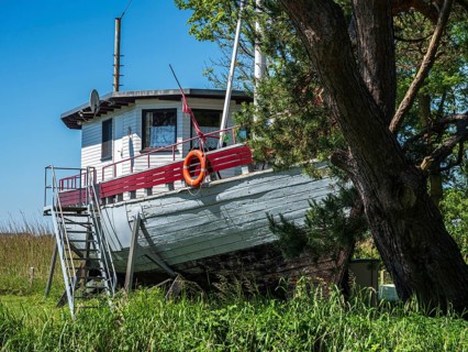 Fishing boat ashore as holiday home, Achterwasser near Ãœckeritz, Usedom island, Mecklenburg,