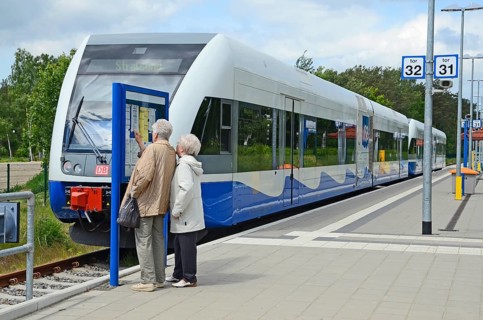 Two people look at the tour list at the local trains that serving Stralsund in Germany and