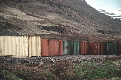 Colorful export import cargo shipping container standing next to each other next to the road at