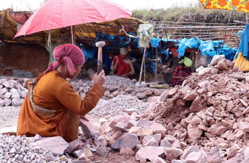 Khasi women breaking stones into different sizes by hammer, in a village in Meghalaya, India on 20