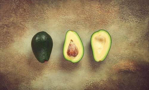 Fresh sliced avocado on the table, top view, food background, concept, menu, food styling