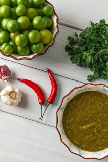 Tkemali sauce, traditional Georgian cuisine, green cherry plum, with ingredients for sauce,
