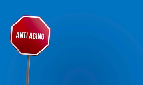 Anti aging, red sign with blue sky