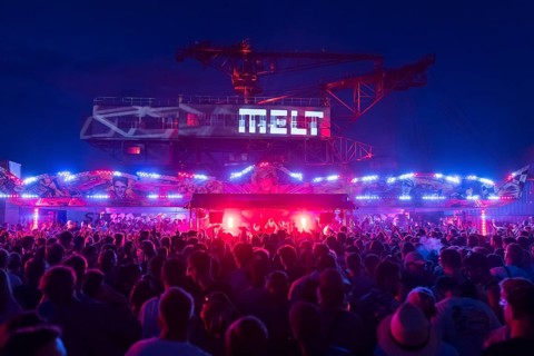 Festival visitors celebrate between bumper cars and excavators at the Melt Festival in Ferropolis