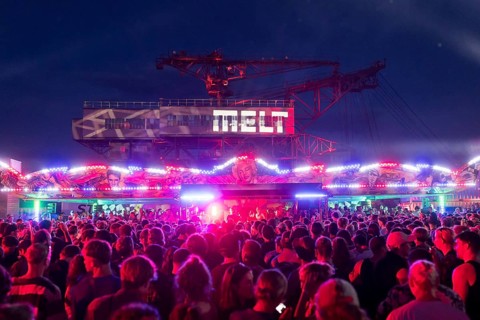 Festival visitors celebrate between bumper cars and excavators at the Melt Festival in Ferropolis