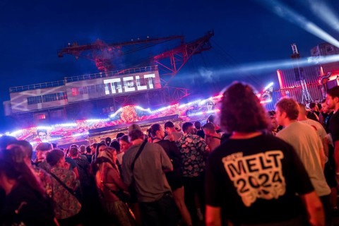 Festival visitors celebrate between bumper cars and excavators at the Melt Festival in Ferropolis