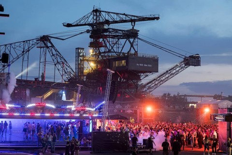 Festival visitors celebrate between excavators at the Melt Festival in Ferropolis on 12 July 2024.