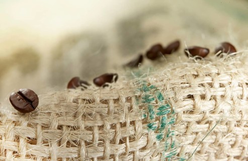Coffee beans on coffee sack, close-up