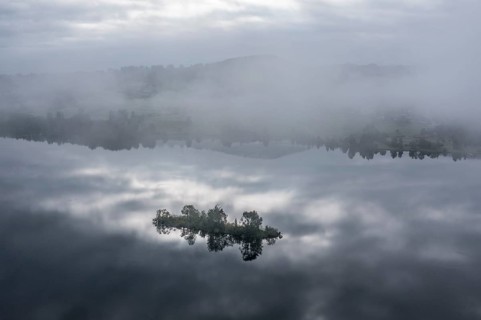 Aerial view over lake Rottachsee to village Petersthal, island in the lake, fog on the lake,