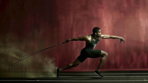 A man poised to throw a javelin against a backdrop of red smoke, emphasizing strength and focus, AI
