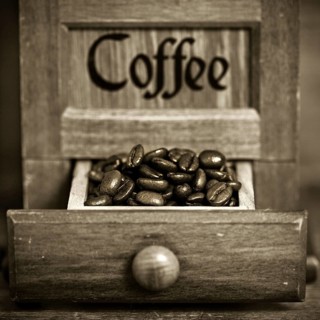Vintage wooden coffee mill in sepia