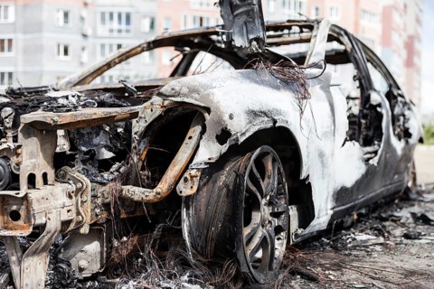 Road wreck accident or arson fire burnt wheel car vehicle junk